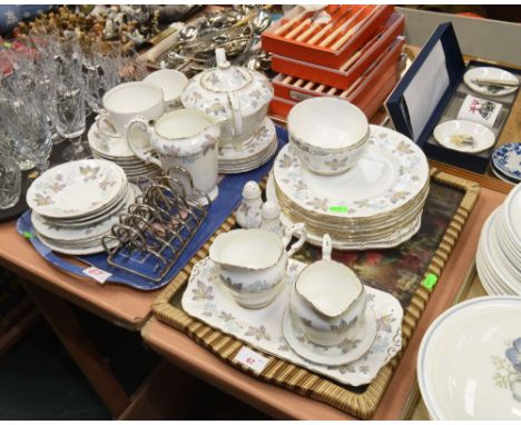 Two trays containing a Paragon Enchantment pattern tea service and two silver plated toast racks