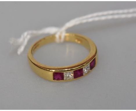 A ruby and diamond ring, the three square cut rubies spaced by two square cut diamonds all mounted in 18ct gold, size M