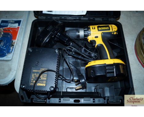 A Dewalt cordless drill with two batteries, charger and instruction manual in fitted case