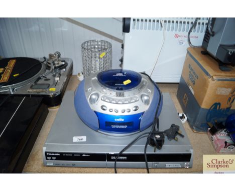 A Panasonic DVD player together with a Cello CD player and a table lamp