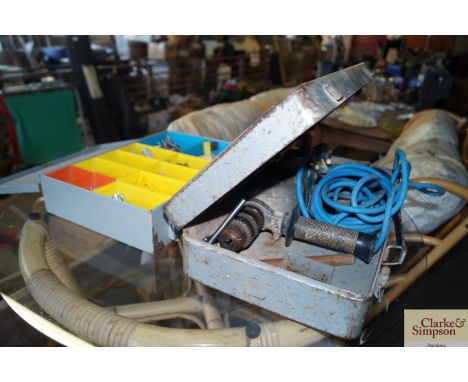 A hammer drill in metal case and a case of fittings and drill bits 