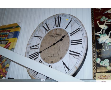 An oval hanging wall clock (AF)