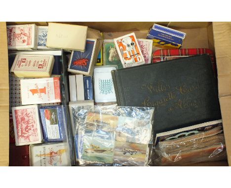 A small collection of cigarette and trade cards, (part-sets), various packs of playing cards and other ephemera.