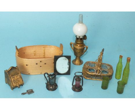 An Edwardian doll's house oil lamp with gilt metal urn base and glass chimney, a gilt metal coal scuttle with shovel, a pierc