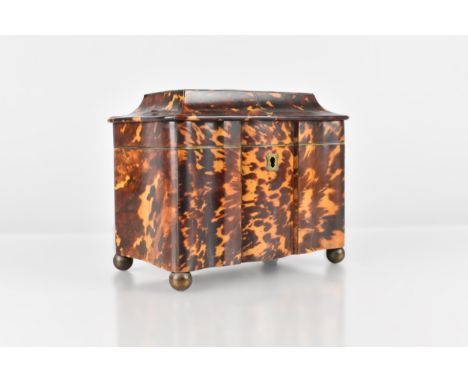 A Georgian Tortoiseshell and Brass Strung Tea Caddy of Sarcophagus Form Raised on Brass Spherical Feet, the Hinged Lid Openin