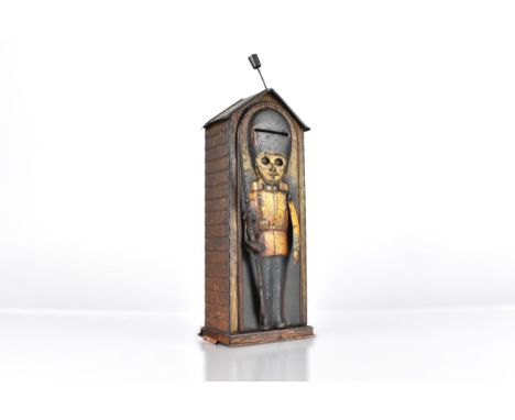 A Vintage Lyons Toffee Tinplate Mechanical Money Bank Modelled as a Coldstream Guardsman, with Push Button Operating Mechanic