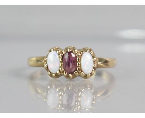 An Opal and Amethyst Ladies Dress Ring, Central Mixed Oval Cut Amethyst Measuring 4.5mm by 2.7mm Approx Supported in Yellow M
