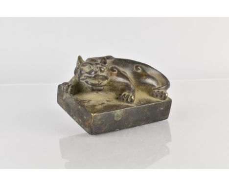 An Archaic Chinese Bronze Seal Modelled as a Crouching Mythical Lion, 10x7x6cm high