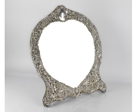 A Large Late Victorian Silver Mounted Easel Back Heart Shaped Mirror, Repousse and Pierced with Decoration Incorporating Cher