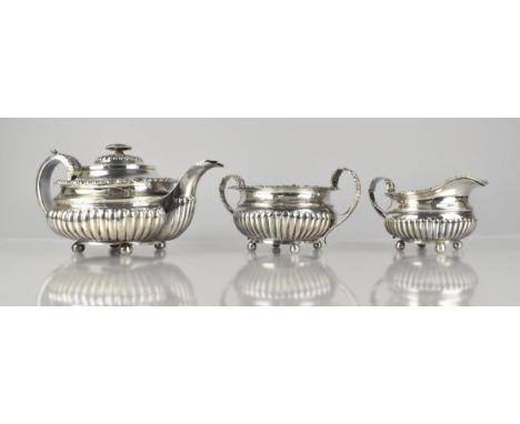 A Georgian Three Piece Tea Service of Reeded Bellied Form and Scrolled Trim by SH, London Hallmarks, 1265g