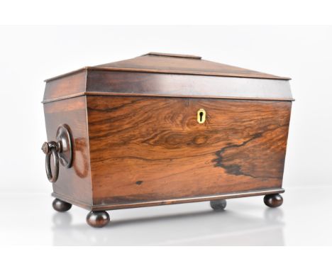 A 19th Century Mahogany Sarcophagus Tea Caddy Raised on Four Bun Feet with Drop Ring Handles, the Hinged Lid Opening to Revea