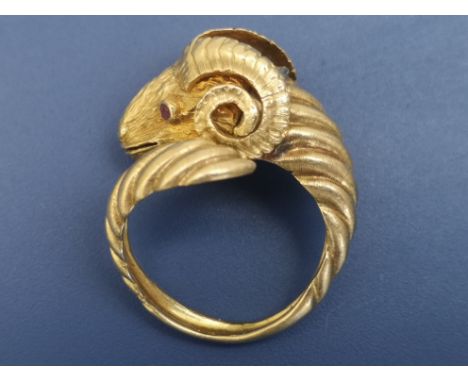 An 18ct gold ram's head ring by Lalounis, having a small rose cut diamond on top of the collar and ruby inset eyes, of open s
