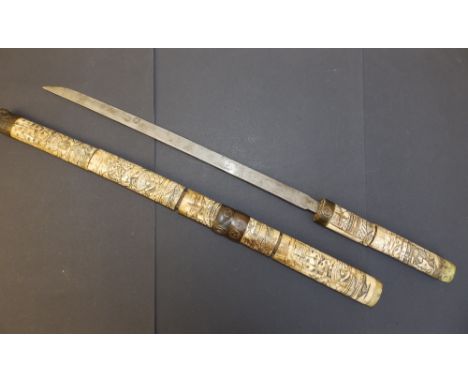 A 19thC Japanese sword with carved bone hilt &amp; scabbard, 28.75" overall  - a/f.