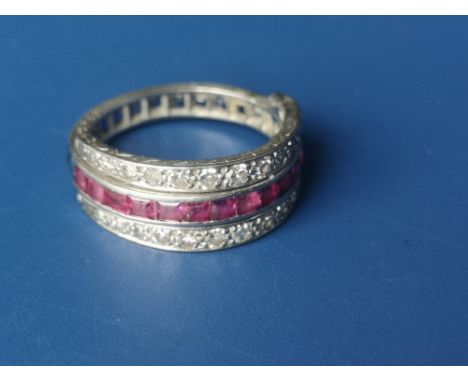 A metamorphic diamond, sapphire &amp; ruby triple eternity style ring in engraved white metal, the coloured stones calibre se