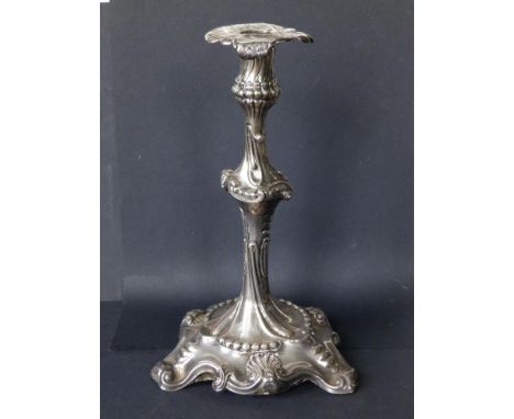 A George III rococo crested silver candlestick, having a leaf-cast sconce, the scroll-moulded stem with asymmetrical knop, th