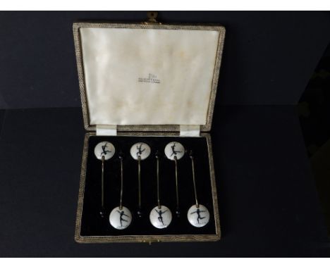 A cased set of six art deco style enamelled silver bean-handled coffee spoons, the bowls decorated to reverse in white guillo