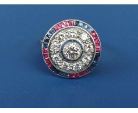 A diamond, ruby &amp; sapphire set target cluster ring in white metal.  Finger size O.