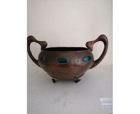 A continental art nouveau two-handled copper bowl with enamel cabochon decoration.