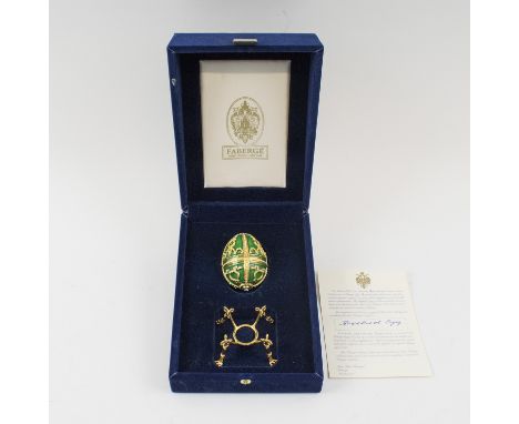 FABERGÉ 'Rosebud egg', 7cm H, green enamel, with gilt and crystal decoration, opening to reveal a rosebud containing a pendan