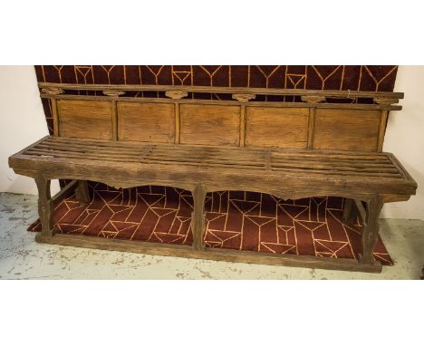 CHINESE OPERA BENCH, 19th century elm with a panelled back and a slatted seat, 236cm L x 96cm H x 55cm D.