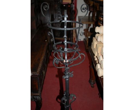 A late Victorian black painted and wrought iron freestanding plant stand, together with a further contemporary wrought iron p