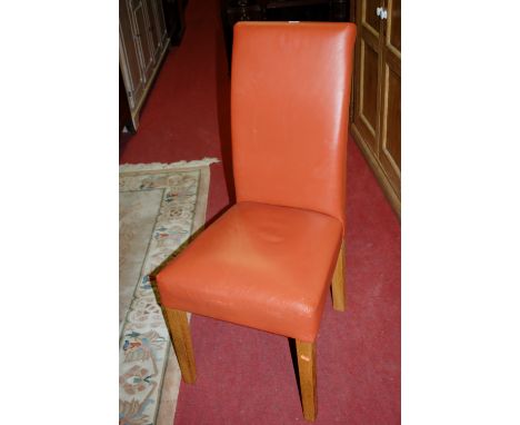 A set of six modern light oak framed and tan leather upholstered dining chairs