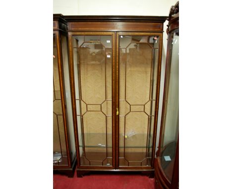 An Edwardian style mahogany and satinwood inlaid double door glazed china display cabinet raised on bracket supports, width 1