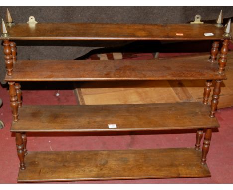 A circa 1900 oak open waterfall four tier hanging wall shelf