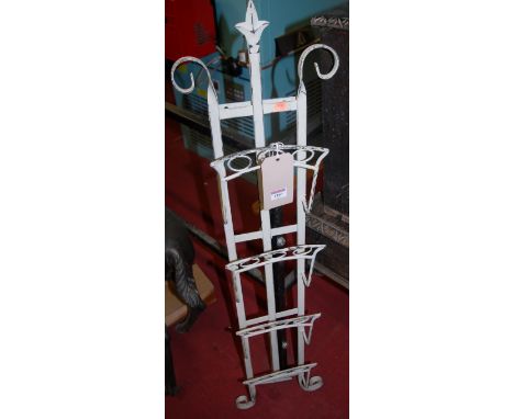 A contemporary wrought metal freestanding easel magazine rack