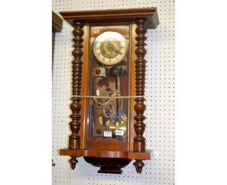 An early 20th century walnut Vienna type drop trunk wall clock