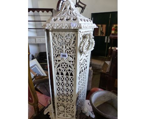 AN ANTIQUE CAST IRON VERITAS STOVE NOW FITTED WITH A LAMP