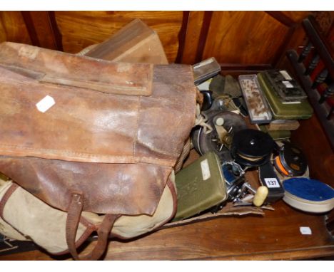 A COLLECTION OF VARIOUS FISHING REELS, FLY TINS AND CONTENTS AND A VINTAGE WICKER CREEL.