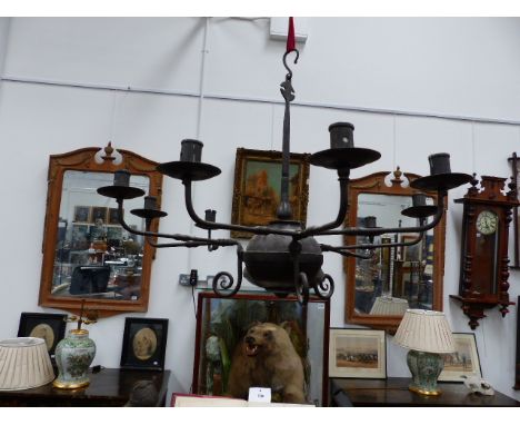 A WROUGHT IRON CHANDELIER.