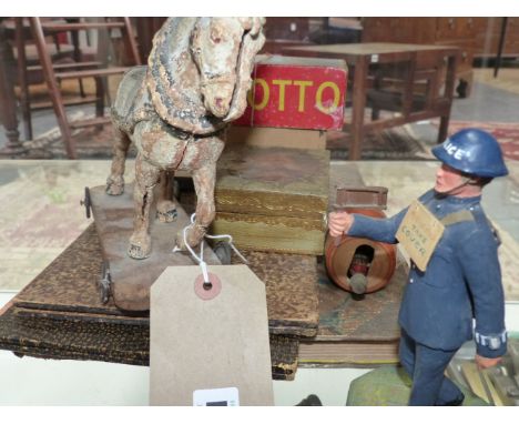 A VINTAGE COMPOSITE PULL ALONG HORSE TOY, A HAND MADE WOODEN FIGURE OF A POLICEMAN, GAMES BOARDS,ETC