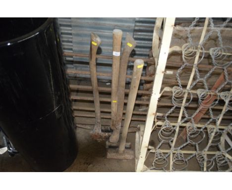 A pick axe; two axes; and a sledge hammer 