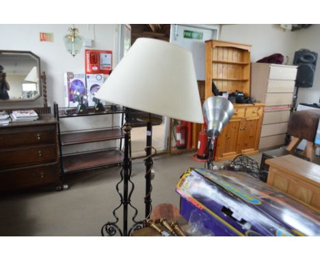 A wrought iron standard lamp