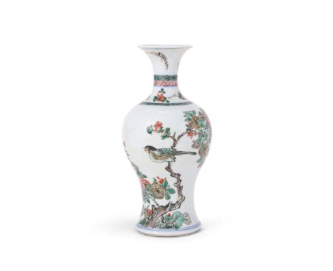 A Chinese Famille Verte vase, Kangxi, painted with a bird perched on the trunk of a flowering tree, the neck and foot with un