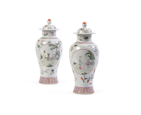 A pair of Chinese Famille Rose vases and covers, Guangxu, well painted with oval reserves to each side enclosing figures in g