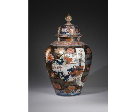 A good large Japanese Arita vase and cover, late 17th or early 18th century, painted to the exterior with panels of pagodas o