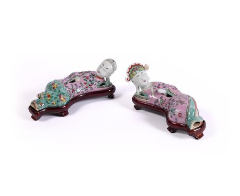 A pair of Chinese Famille Rose figural wall vases, Qing dynasty, 19th century, modelled lying on their sides in mirror image,