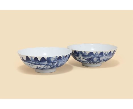 A pair of Chinese blue and white lobed bowls, 19th century, decorated in Kangxi style, with fisherman and buffalo in a rivers