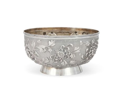 A Chinese silver bowl, late Qing dynasty, circular, richly chased with a wide band of flowers enclosing a vacant shield, stam