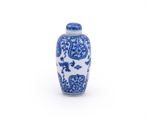 A Chinese blue and white ovoid jar and cover, Kangxi, painted with flower-filled lappets, 19.5cm highProvenance: From a Famil