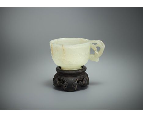A Chinese pale celadon jade 'Dragon' cup, with dragon-head handle and carved in relief with raised bosses, 3.8cm high, with w