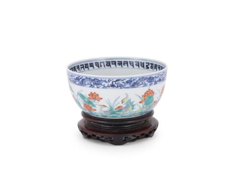 A Chinese Doucai 'Lotus pond' bowl, with steep rounded sides rising from a slightly recessed base, the exterior painted with 