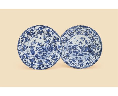 A pair of large Chinese blue and white dishes, Kangxi, painted to the interior with deer and crane in a fenced garden with ma