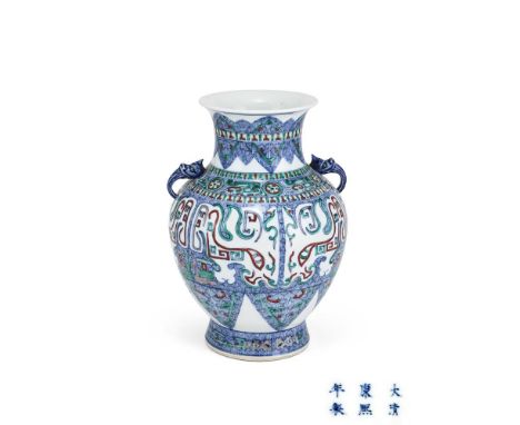 A Chinese doucai twin handled vase, 19th century, the baluster body on splayed feet, the body painted with taotie masks and t