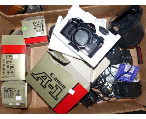 A boxed A1 Canon camera; 3 boxed lenses, 28/2.8; 50/1.8; 135; other accessories