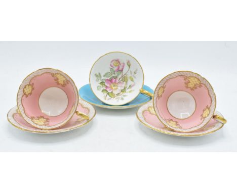 A trio of Aynsley cups and saucers to include Wild Rose pattern on blue background together with 2 pink and gilt duos (6).  I