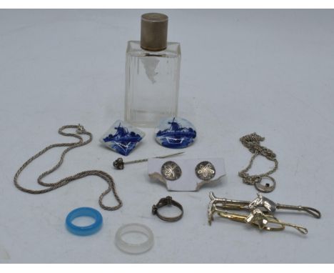 A collection of items to include silver topped scent bottle, silver chains, gold plated hunting tie pins, Delft-style brooche